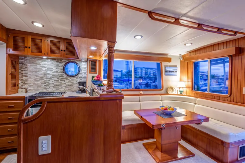 Slide: The Image of Luxurious 2007 Krogen 44' Widebody yacht interior with elegant wood finishes and cozy seating area. - 5