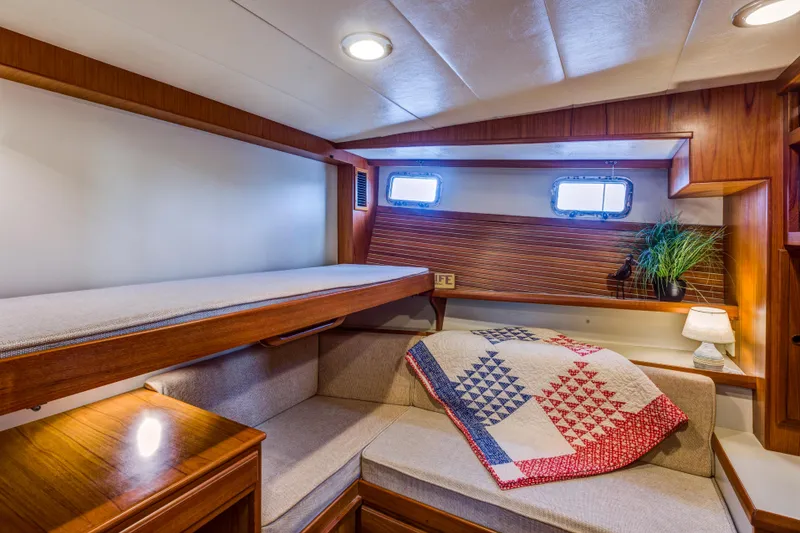 Slide: The Image of Cozy cabin interior of 2007 Krogen 44' Widebody yacht with bunk and quilt. - 9