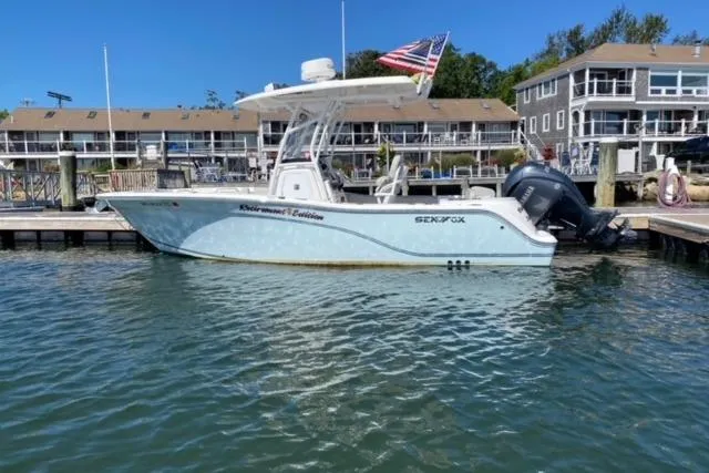 The Image of 2024 Sea Fox 228 Commander boat docked, featuring sleek design and American flag. - 0
