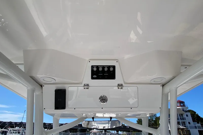 Slide: The Image of 2024 Sea Fox 228 Commander boat console with controls and storage compartment. - 12