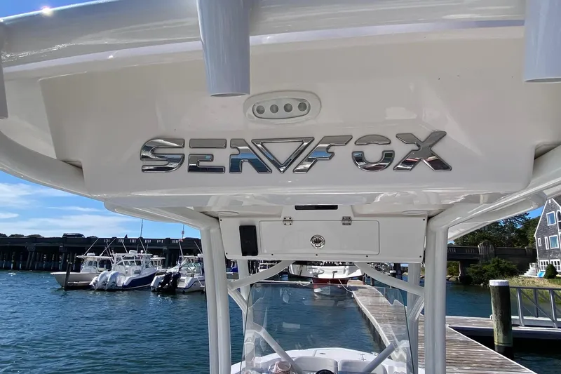 Slide: The Image of 2024 Sea Fox 228 Commander boat docked at marina, showcasing sleek design. - 13