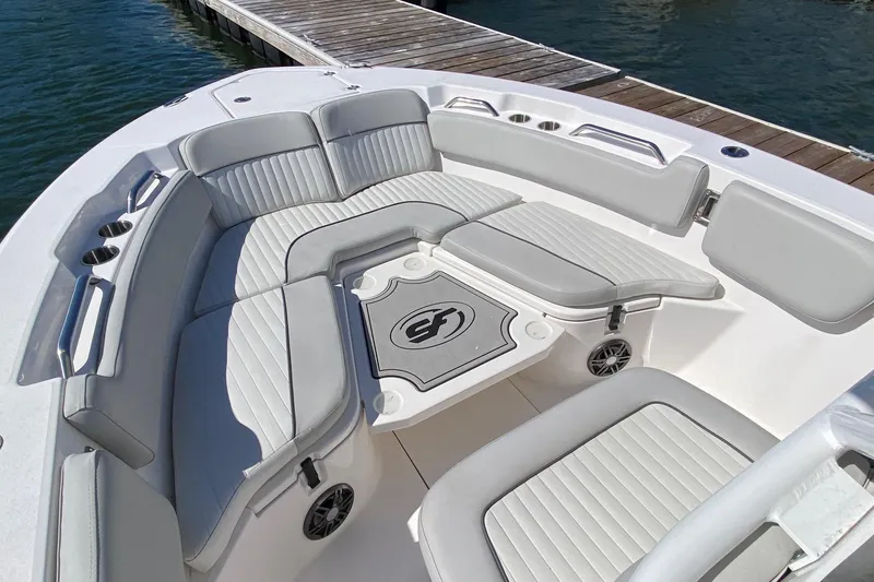 Slide: The Image of 2024 Sea Fox 228 Commander boat with spacious seating and sleek design at dockside. - 17
