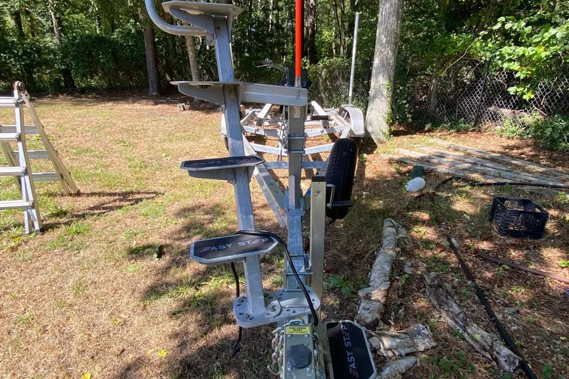 Slide: The Image of 2024 Sea Fox 228 Commander trailer with Easy Step ladder in a wooded area. - 25