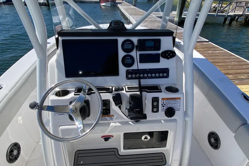 Slide: The Image of 2024 Sea Fox 228 Commander boat console with steering wheel and navigation controls. - 7