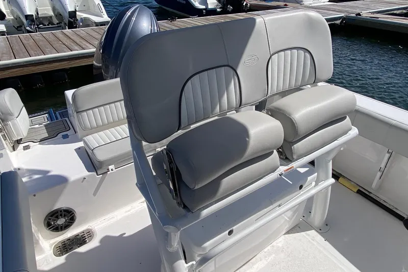 Slide: The Image of 2024 Sea Fox 228 Commander boat interior with cushioned seating at the dock. - 14