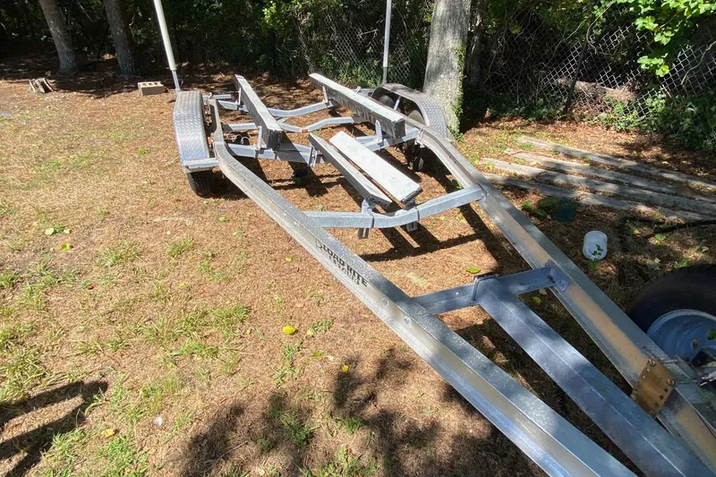 Slide: The Image of Trailer for 2024 Sea Fox 228 Commander boat on grassy area. - 24