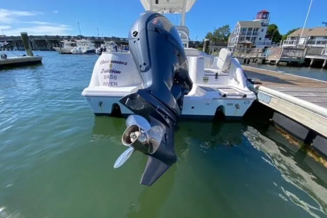 Slide: The Image of 2024 Sea Fox 228 Commander boat docked with outboard motor in marina. - 3