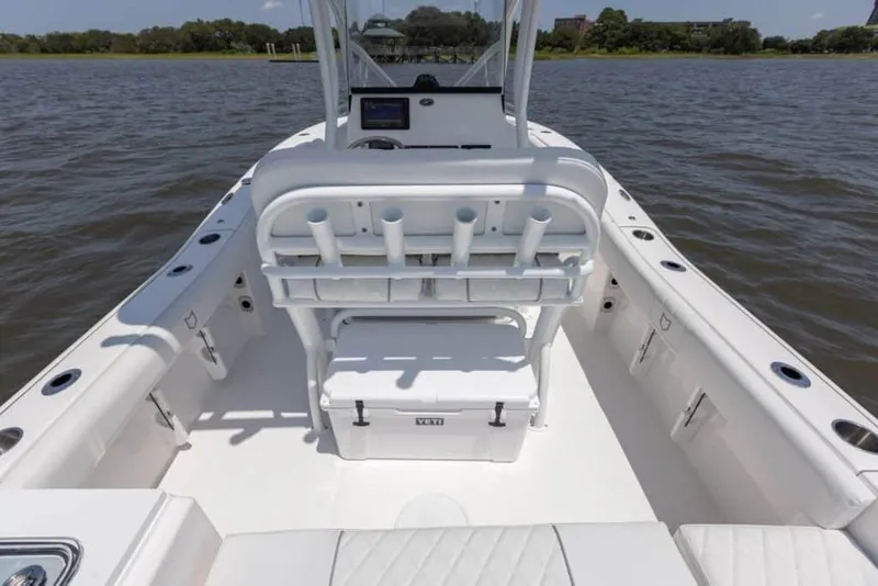 Slide: The Image of Manufacturer Provided Image: 2024 Sea Fox 228 Commander boat interior with rod holders and cooler on a calm lake. - 34