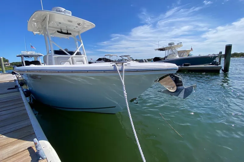 Slide: The Image of 2024 Sea Fox 228 Commander boat docked on a sunny day. - 4