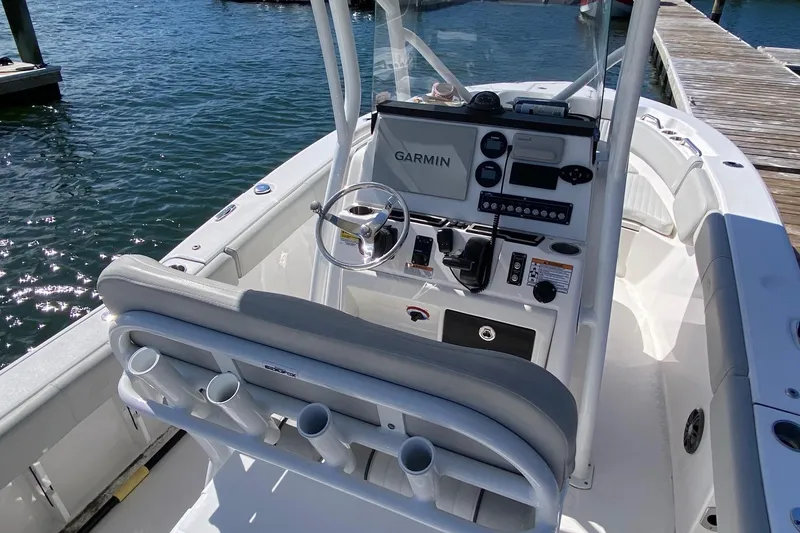 Slide: The Image of 2024 Sea Fox 228 Commander boat cockpit with Garmin navigation system, docked by the water. - 6