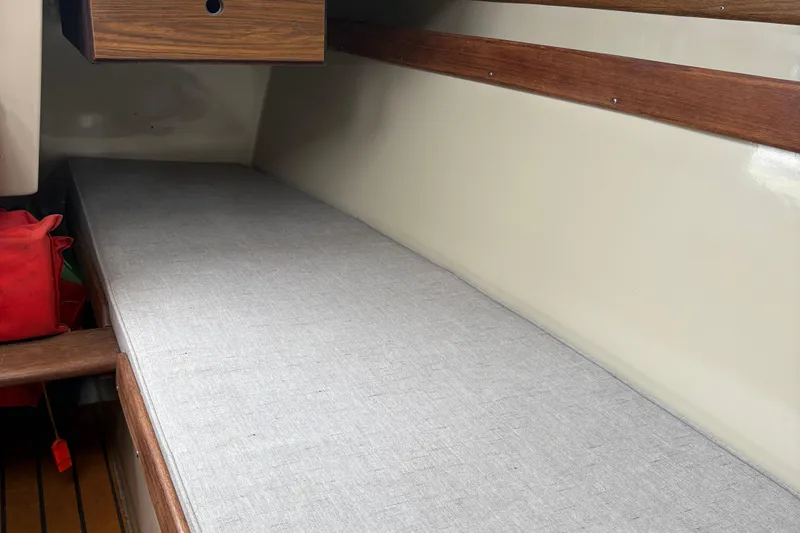 Slide: The Image of Interior of 1983 Sonic 23 boat with cushioned bench and wooden accents. - 19