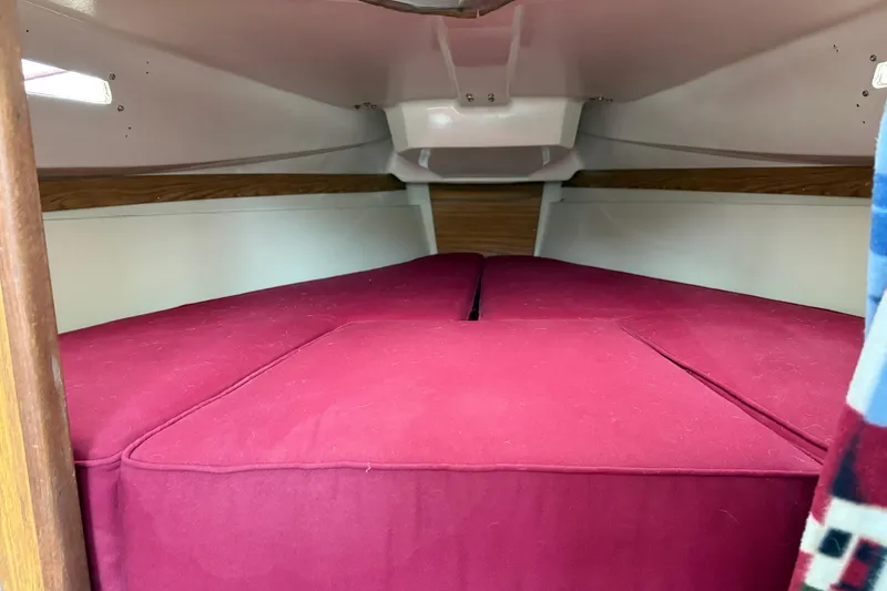 Slide: The Image of Interior cabin of 1983 Sonic 23 boat with red cushions. - 22