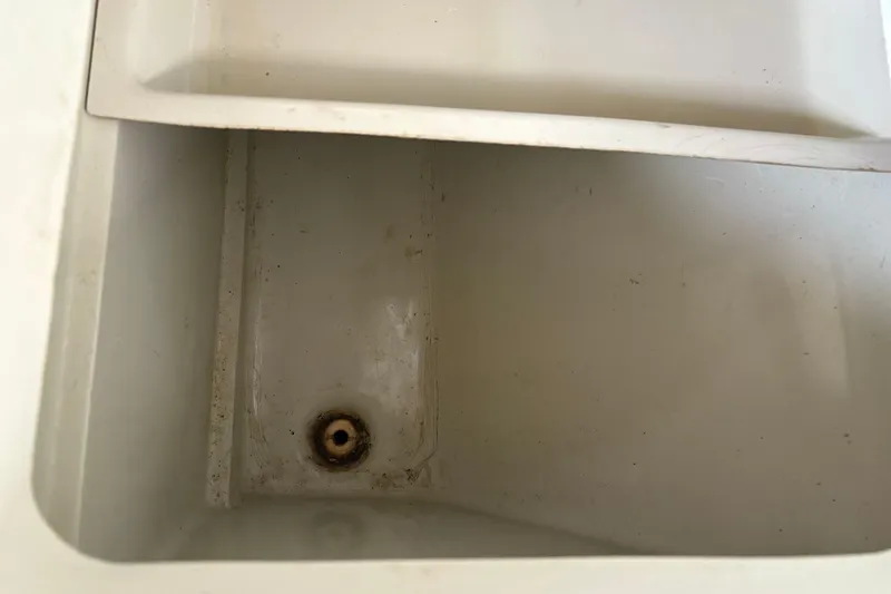 Slide: The Image of Interior of a 1983 Sonic 23 boat compartment with drain hole. - 27