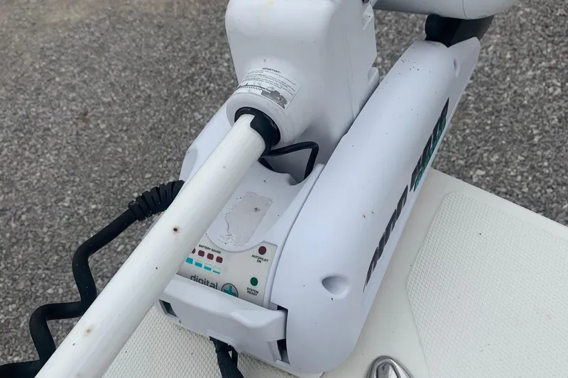 Slide: The Image of 2016 Ranger 2510 Bay Ranger boat motor with digital controls on a textured surface. - 10