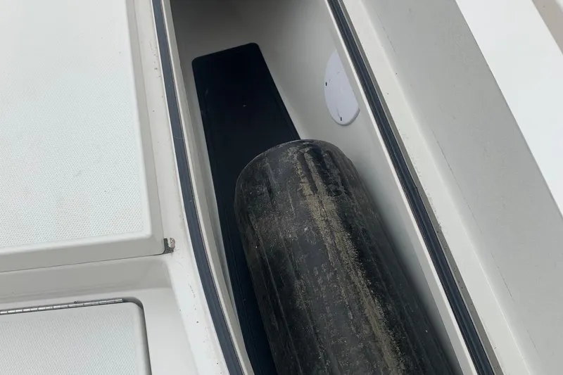 Slide: The Image of Storage compartment of 2016 Ranger 2510 Bay Ranger boat with a fender inside. - 14