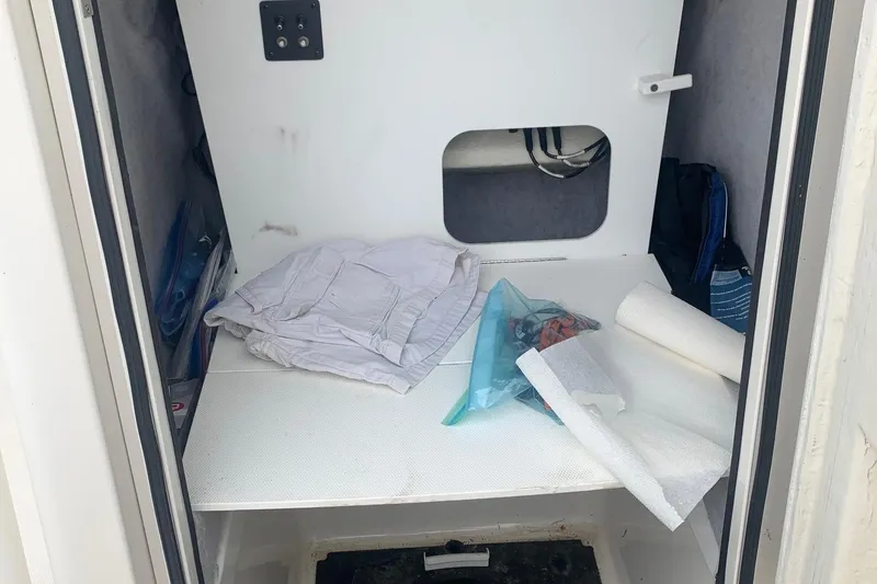 Slide: The Image of 2016 Ranger 2510 Bay Ranger interior storage with clothes and supplies. - 15