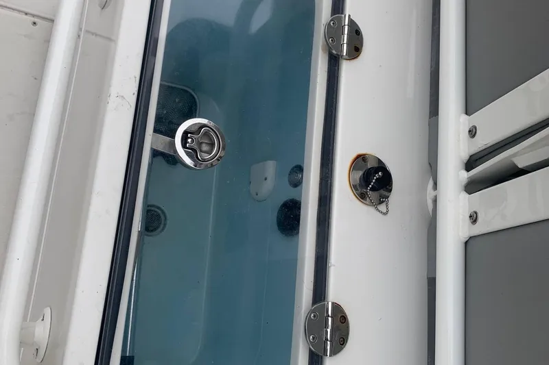 Slide: The Image of 2016 Ranger 2510 Bay Ranger boat deck with metal fittings and glass panel. - 17