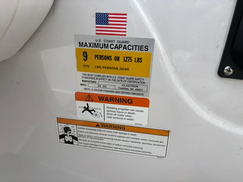 Slide: The Image of US Coast Guard capacity label on Glastron 205 MXSF boat, year 2013. - 12