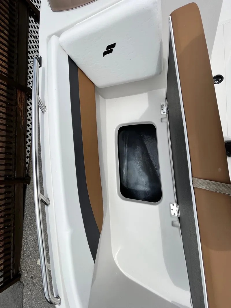 Slide: The Image of 2024 Starcraft SVX 171 boat interior storage compartment and seating area. - 13