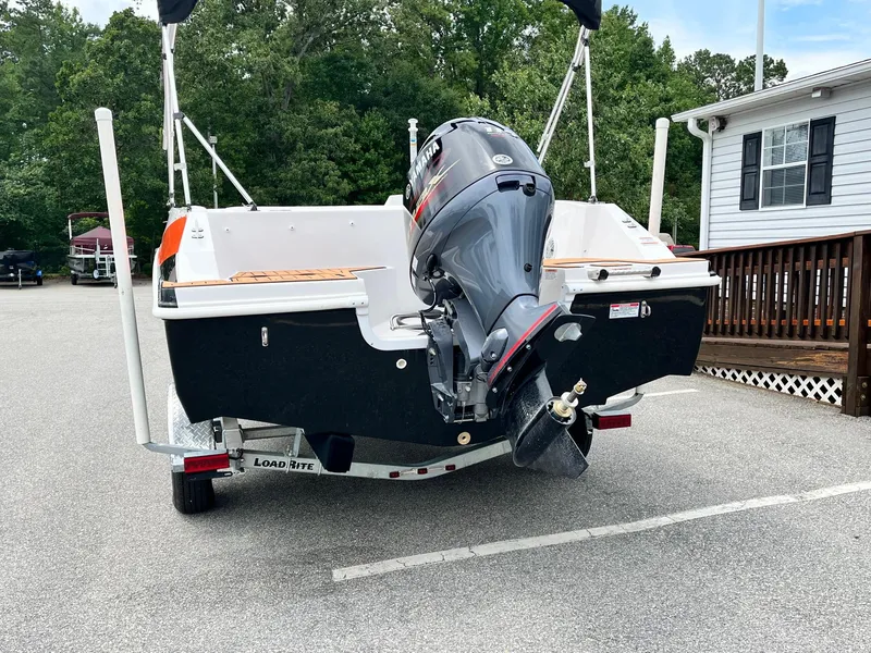 Slide: The Image of 2024 Starcraft SVX 171 boat on a Load Rite trailer, rear view with outboard motor. - 2