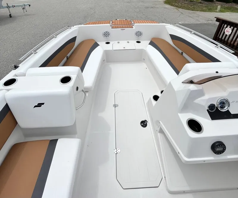 Slide: The Image of 2024 Starcraft SVX 171 boat interior with white and brown seating, dashboard, and storage compartments. - 5