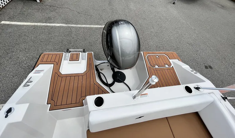 Slide: The Image of 2024 Starcraft SVX 171 boat with outboard motor and teak-style deck. - 9