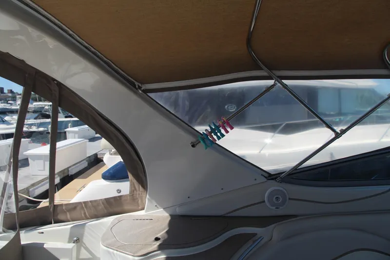 Slide: The Image of 2004 Larson 370 Cabrio boat interior with clothespins and marina view. - 12