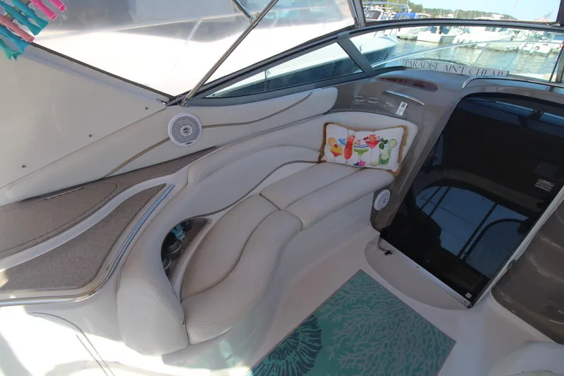 Slide: The Image of 2004 Larson 370 Cabrio boat interior with plush seating and decorative pillow. - 13