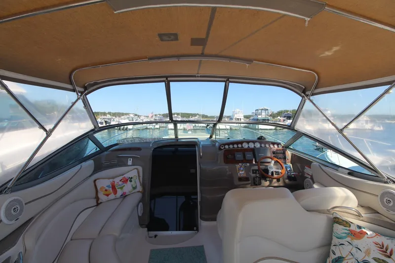 Slide: The Image of Interior view of 2004 Larson 370 Cabrio boat with helm and seating area. - 14