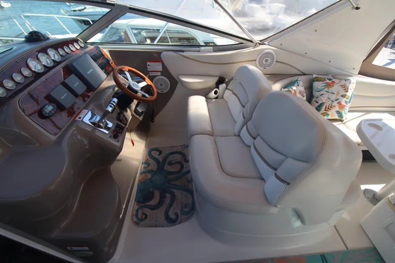 Slide: The Image of Interior of 2004 Larson 370 Cabrio boat with plush seating and modern dashboard. - 15