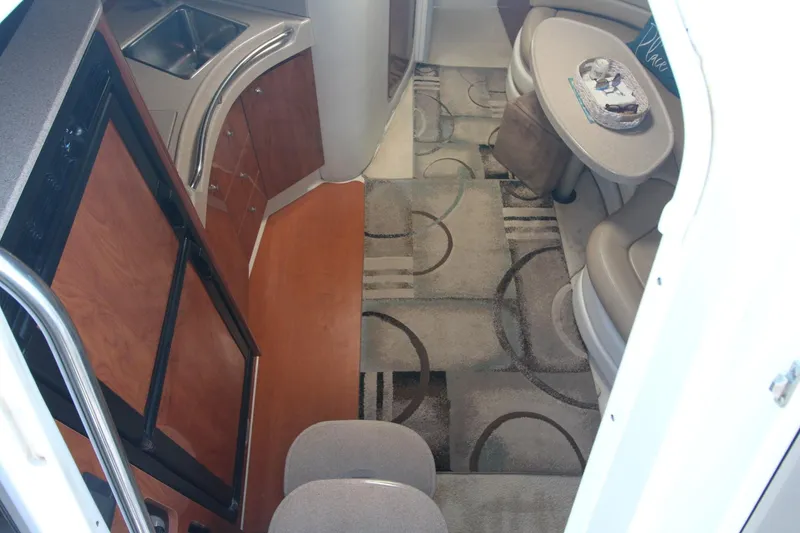Slide: The Image of Interior of 2004 Larson 370 Cabrio yacht with kitchen and seating area. - 18