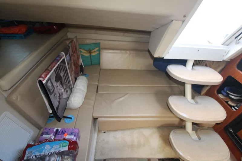 Slide: The Image of Interior of 2004 Larson 370 Cabrio boat with beige seating and compact staircase. - 22