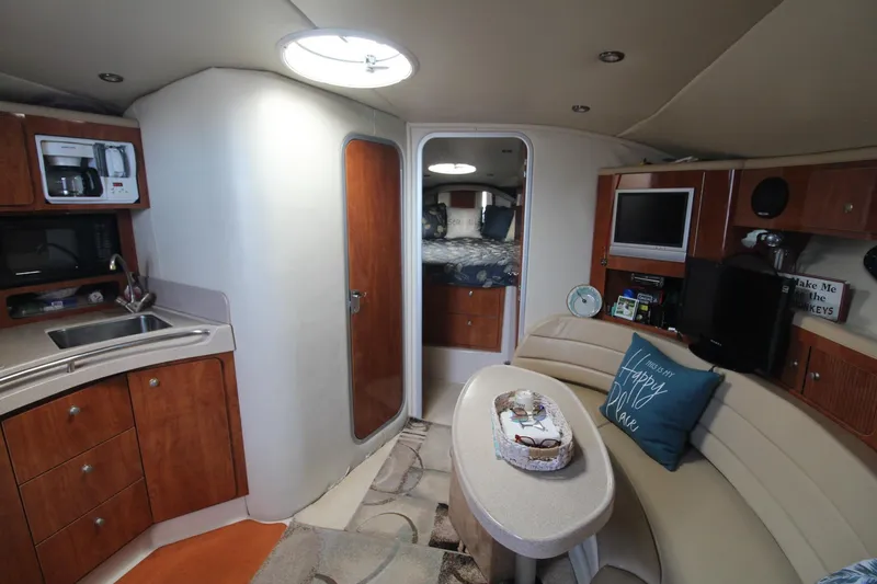 Slide: The Image of Interior of 2004 Larson 370 Cabrio yacht with kitchenette and cozy seating area. - 25