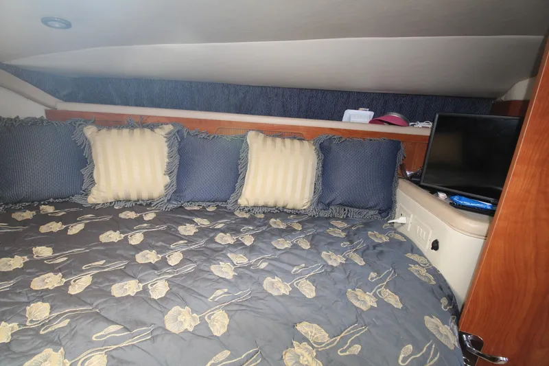 Slide: The Image of Cozy cabin interior of 2004 Larson 370 Cabrio with floral bedding and pillows. - 28