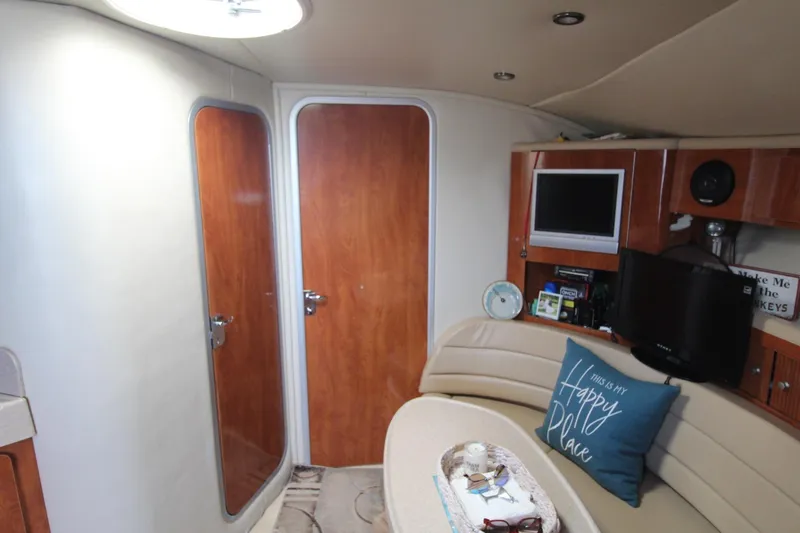 Slide: The Image of Interior of 2004 Larson 370 Cabrio yacht with cozy seating and entertainment area. - 29