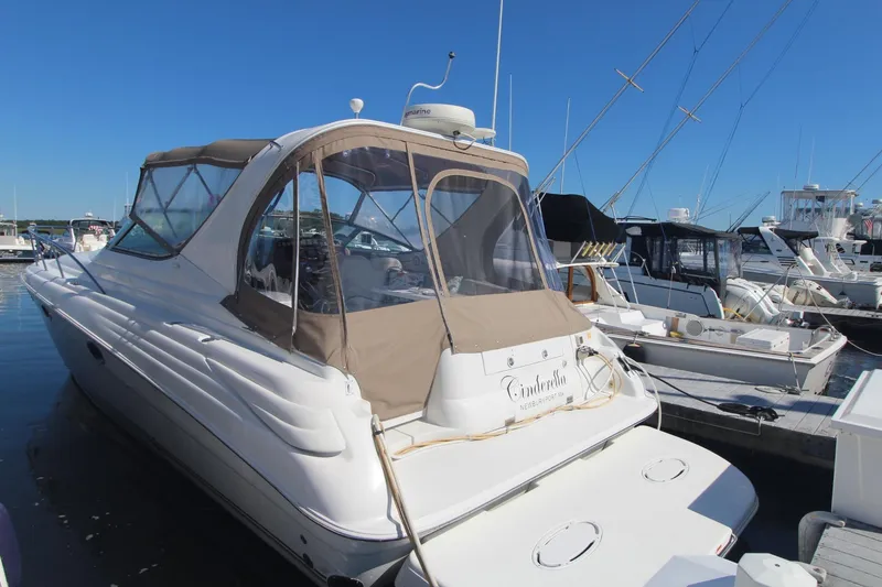 Slide: The Image of 2004 Larson 370 Cabrio yacht docked at marina under clear blue sky. - 3