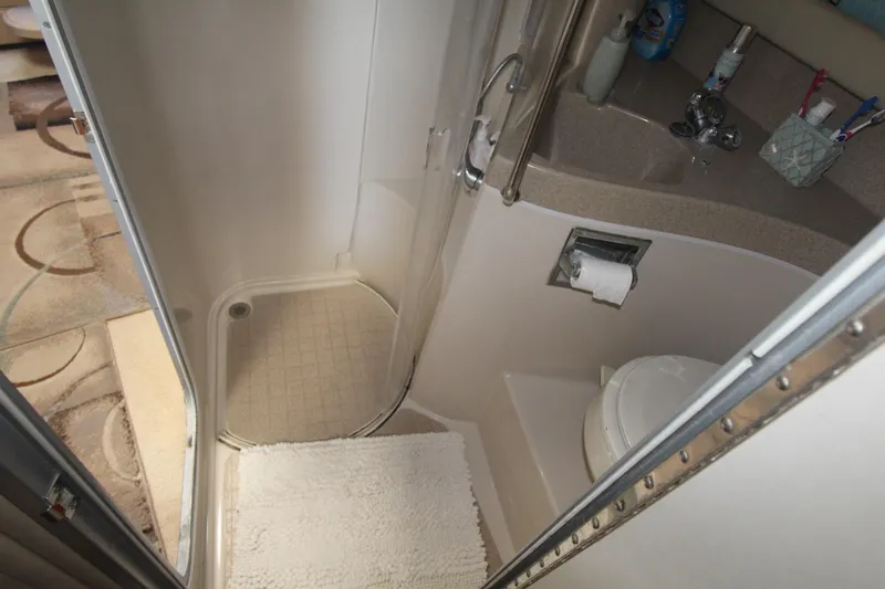 Slide: The Image of Bathroom interior of 2004 Larson 370 Cabrio boat with shower and toilet. - 31