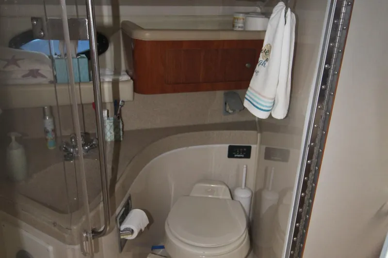 Slide: The Image of Bathroom interior of 2004 Larson 370 Cabrio boat, featuring toilet and shower area. - 33