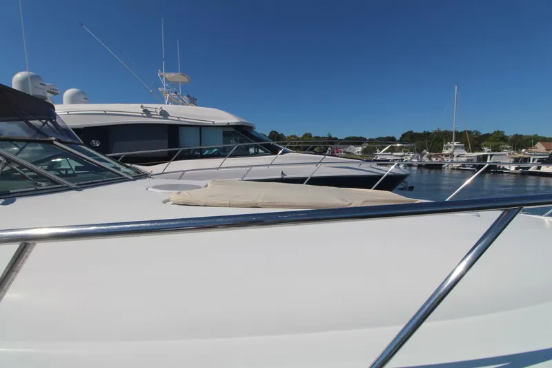 Slide: The Image of 2004 Larson 370 CABRIO yacht docked at a marina under clear blue skies. - 7