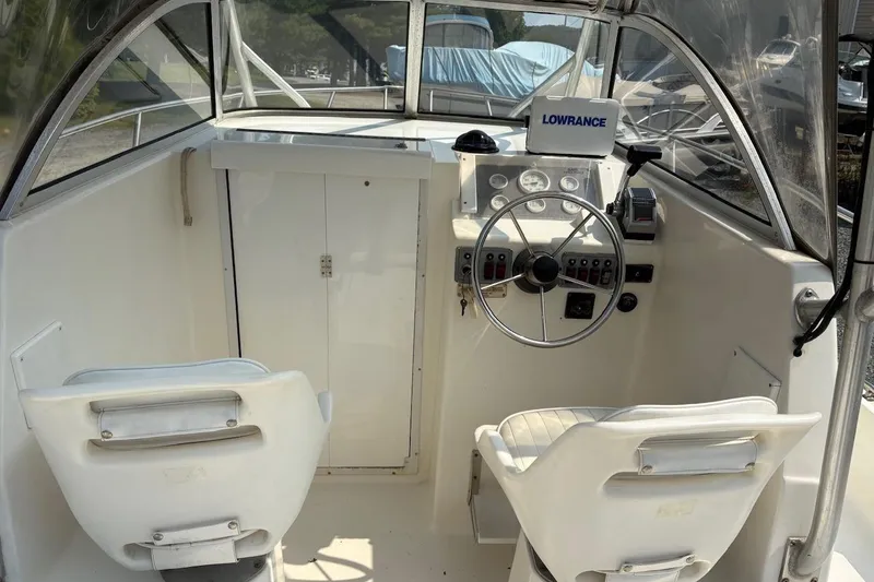 Slide: The Image of 1995 Baha Cruisers 240 Walkaround boat interior with steering wheel and navigation equipment. - 12