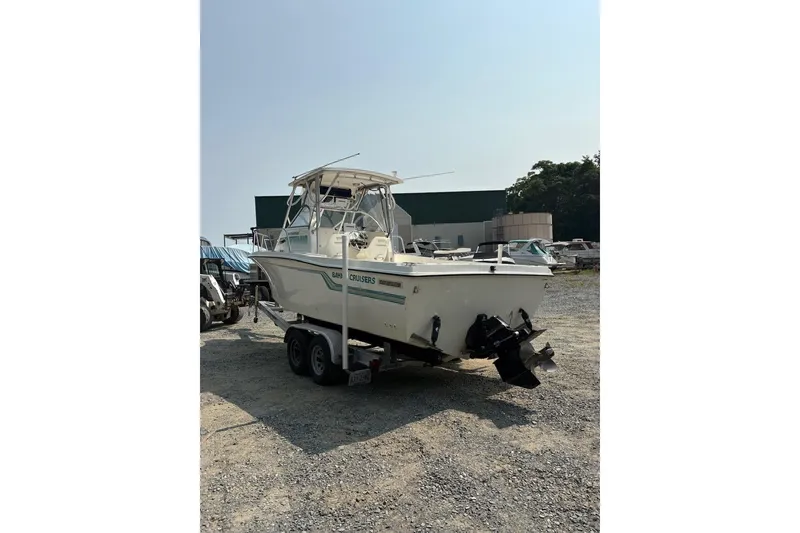Slide: The Image of 1995 Baha Cruisers 240 Walkaround boat on trailer in outdoor storage area. - 3