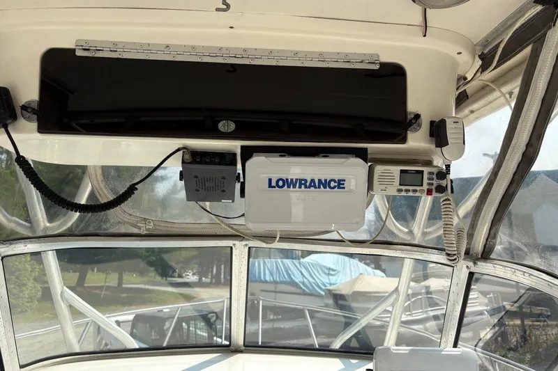 Slide: The Image of Interior view of a 1995 Baha Cruisers 240 Walkaround boat with navigation equipment. - 8