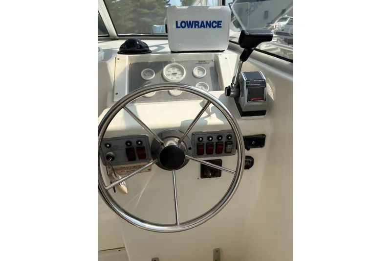 Slide: The Image of Steering wheel and controls of 1995 Baha Cruisers 240 Walkaround boat. - 9