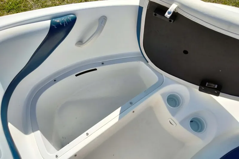 Slide: The Image of 2003 Sea-Doo Utopia 185 boat interior storage compartment with cup holders. - 14