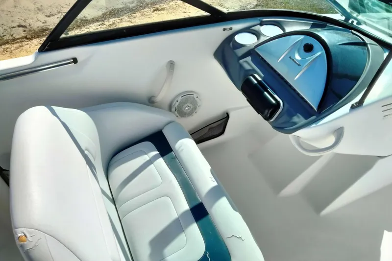 Slide: The Image of 2003 Sea-Doo Utopia 185 boat interior with white and blue seating and dashboard. - 17