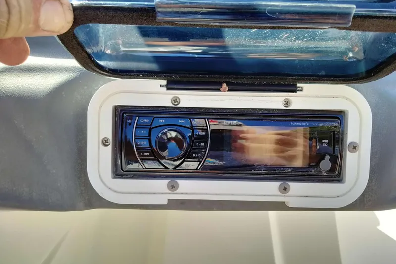 Slide: The Image of 2003 Sea-Doo Utopia 185 boat stereo system with protective cover open. - 19