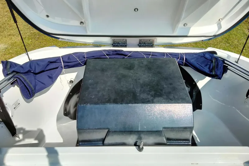 Slide: The Image of Open engine compartment of 2003 Sea-Doo Utopia 185 boat, showing storage and cover. - 21