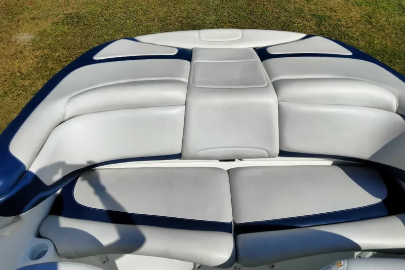 Slide: The Image of 2003 Sea-Doo Utopia 185 boat interior with white and blue cushioned seating. - 23
