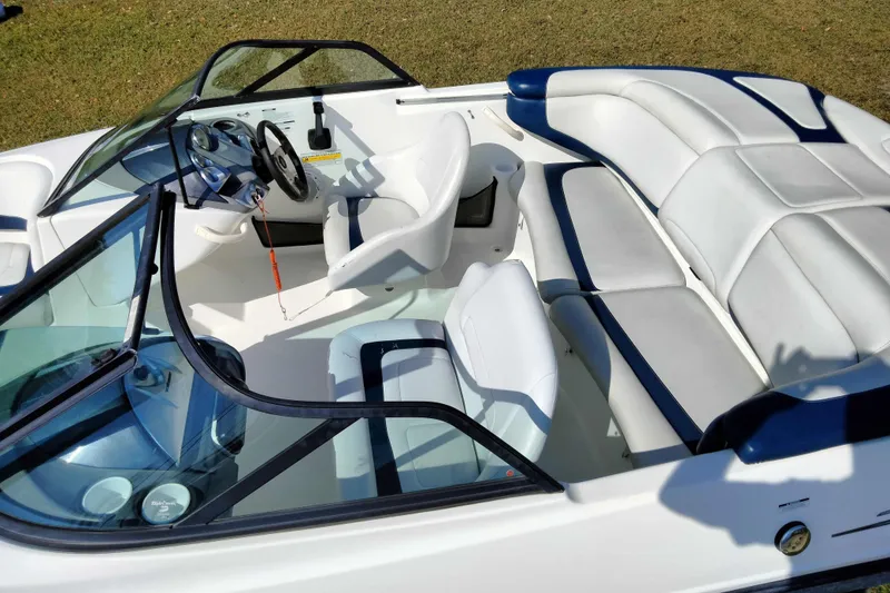 Slide: The Image of 2003 Sea-Doo Utopia 185 boat interior with white and blue seating, steering wheel, and dashboard. - 6