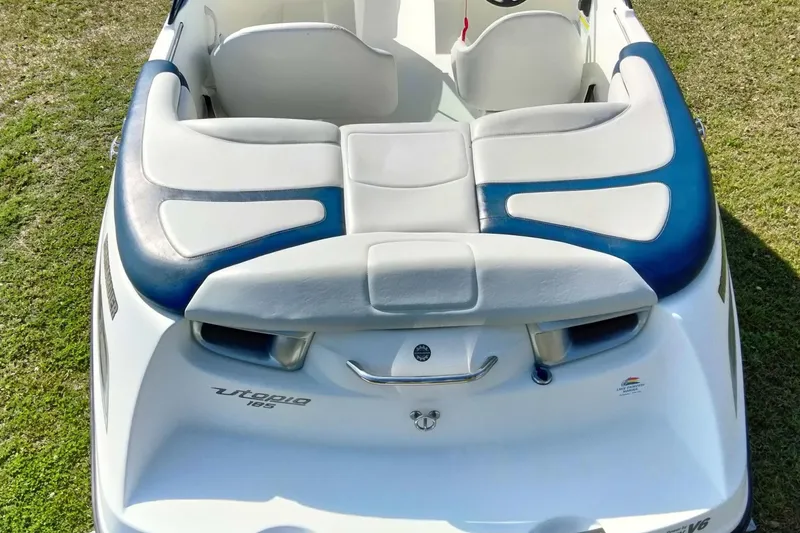 Slide: The Image of 2003 Sea-Doo Utopia 185 boat with blue and white seating, rear view. - 9